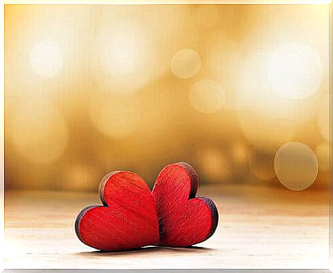 Two-red-hearts-on-a-wooden-table