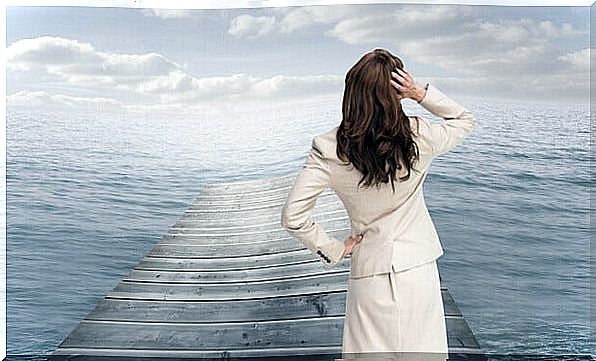 woman on a pontoon facing the sea