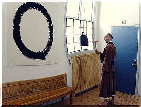 monk in front of enso