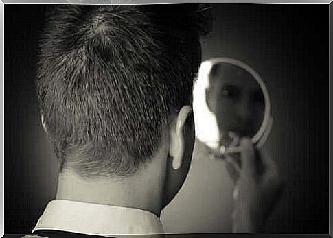 A man looking at himself in the mirror